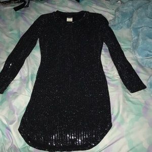 A sparkly black dress with a bright reflection.